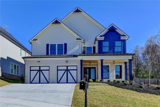 craftsman inspired home featuring a front yard and a garage