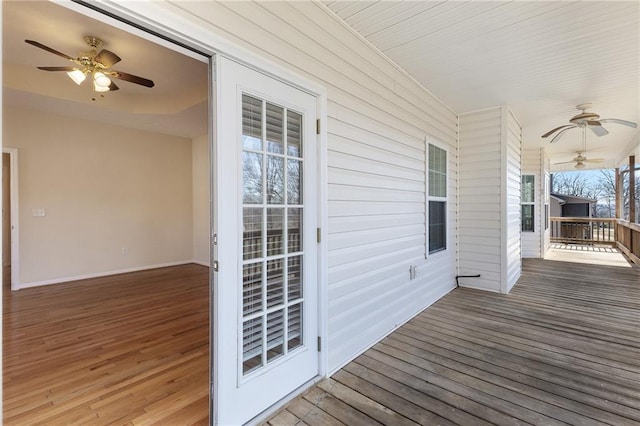 wooden terrace featuring ceiling fan and a porch