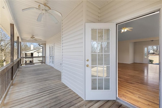 wooden terrace with a ceiling fan