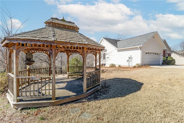 exterior space with a garage and a gazebo