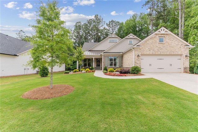 craftsman-style home featuring a front yard and a garage