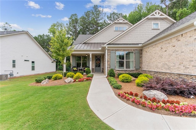 property entrance with a standing seam roof, central AC, metal roof, and a lawn