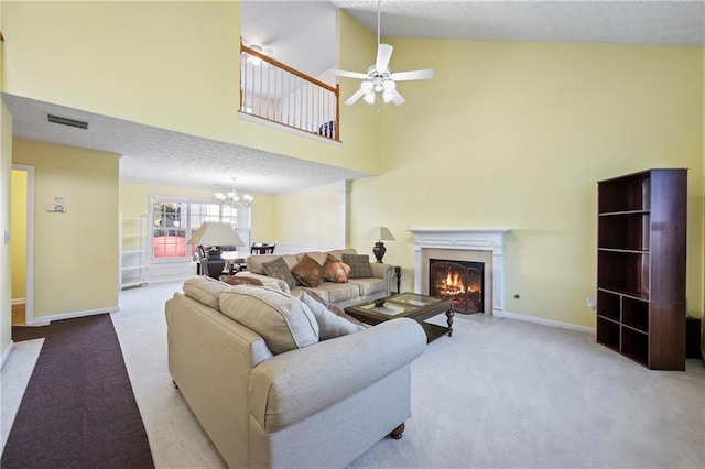 living room with a textured ceiling, light carpet, high vaulted ceiling, and ceiling fan with notable chandelier