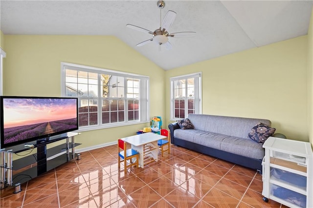 living room featuring tile patterned floors, ceiling fan, and vaulted ceiling