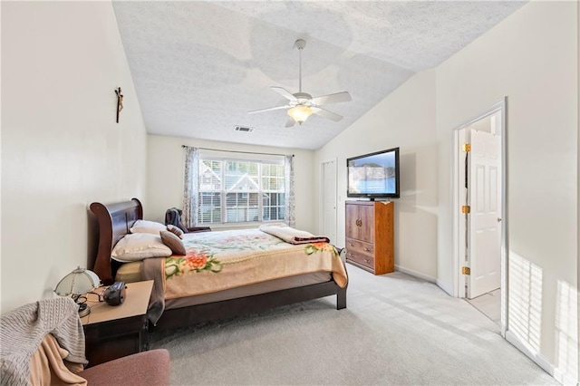 carpeted bedroom featuring ceiling fan, a textured ceiling, and vaulted ceiling