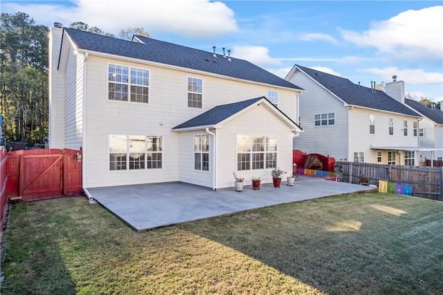 rear view of property with a lawn and a patio