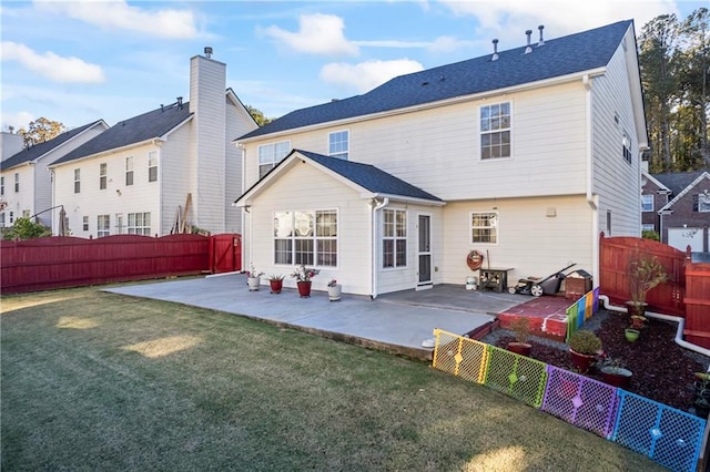 rear view of house featuring a patio area and a yard