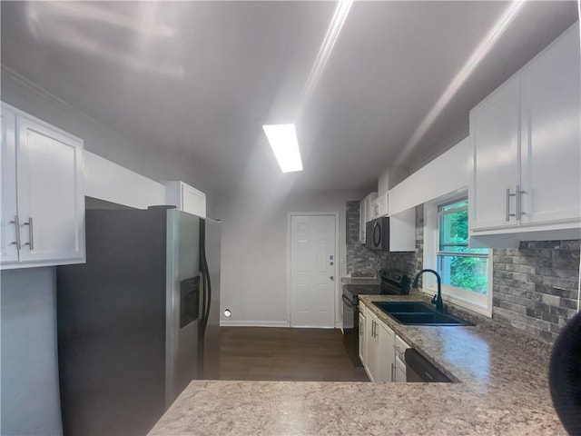 kitchen featuring black appliances, white cabinets, sink, and tasteful backsplash