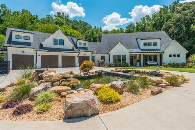 modern inspired farmhouse with an attached garage, board and batten siding, driveway, and roof with shingles