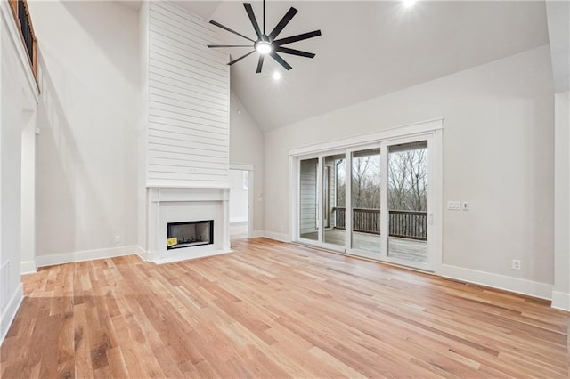 unfurnished living room featuring high vaulted ceiling, ceiling fan, and light wood-type flooring