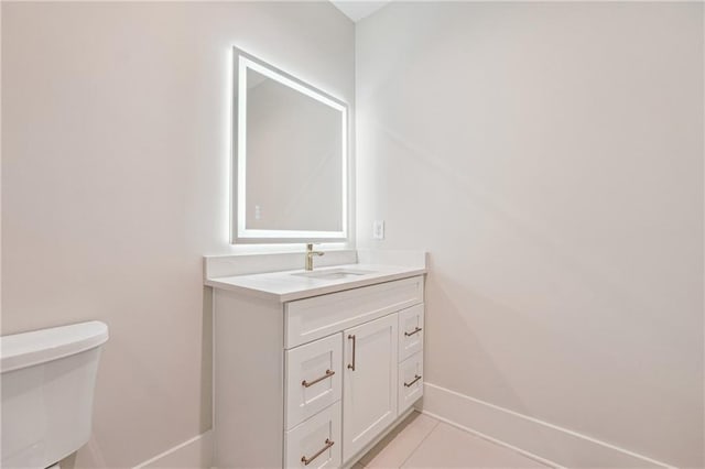 bathroom with vanity, tile patterned floors, and toilet