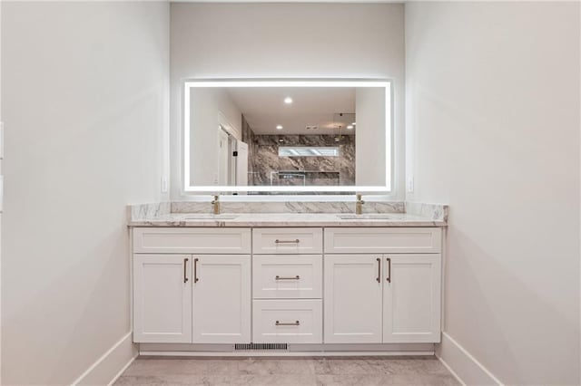 bathroom with vanity and tiled shower