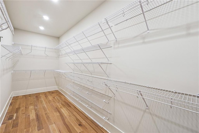 walk in closet with wood-type flooring