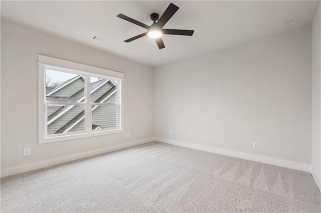 carpeted spare room with ceiling fan