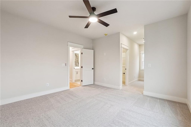 empty room featuring light colored carpet and ceiling fan