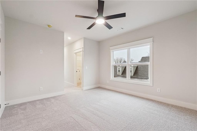 unfurnished room featuring light colored carpet and ceiling fan