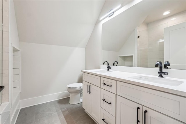 bathroom featuring tile patterned flooring, vanity, a tile shower, vaulted ceiling, and toilet