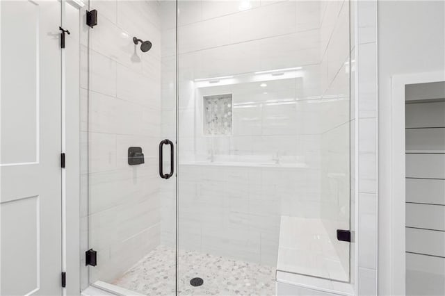 bathroom featuring a shower with shower door