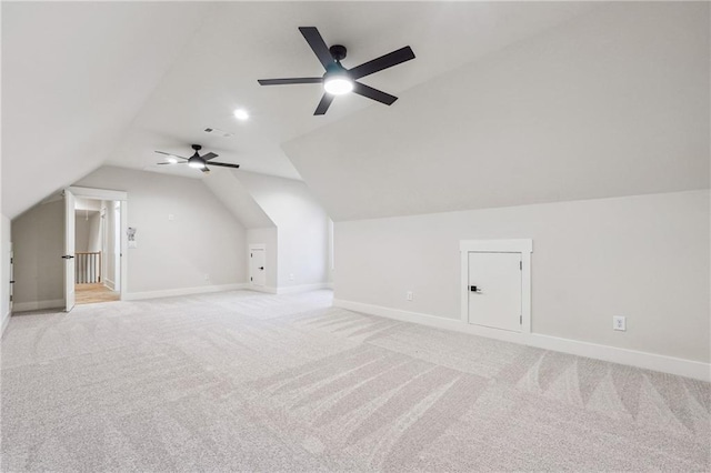 additional living space featuring lofted ceiling and light colored carpet