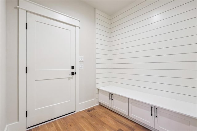 mudroom with light hardwood / wood-style floors