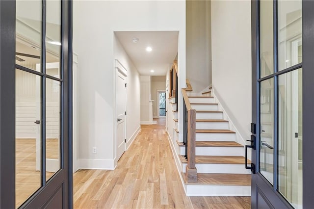 foyer featuring light hardwood / wood-style floors and french doors