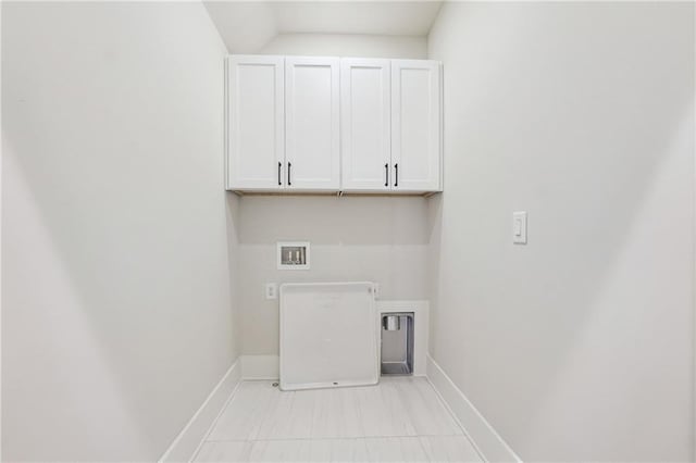 clothes washing area with cabinets and washer hookup