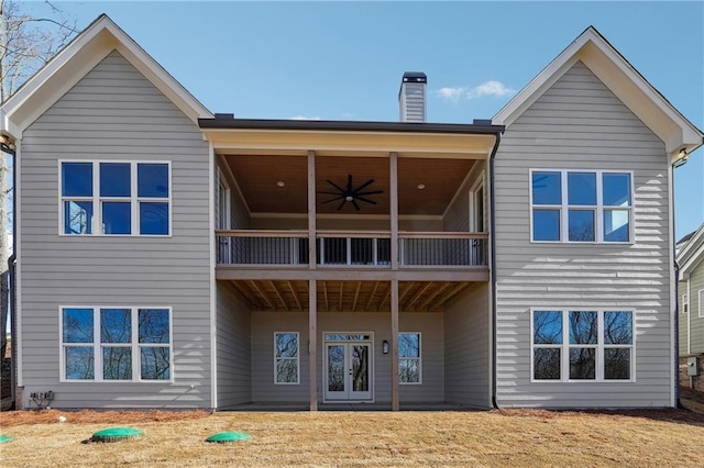 back of house with french doors and ceiling fan