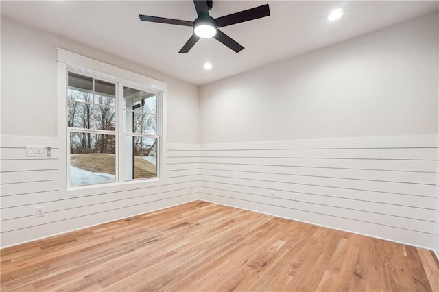 spare room featuring wooden walls and hardwood / wood-style floors