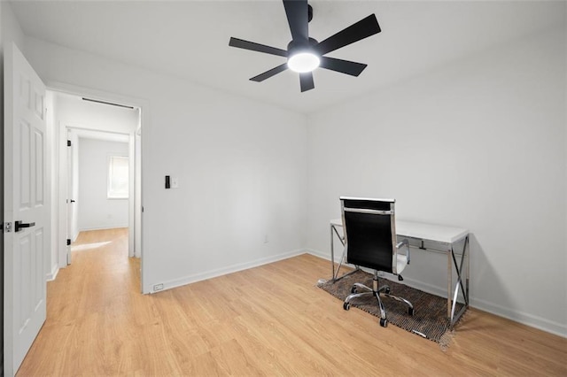 home office with ceiling fan and light hardwood / wood-style flooring