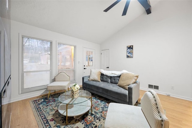 living room featuring ceiling fan, hardwood / wood-style floors, and high vaulted ceiling