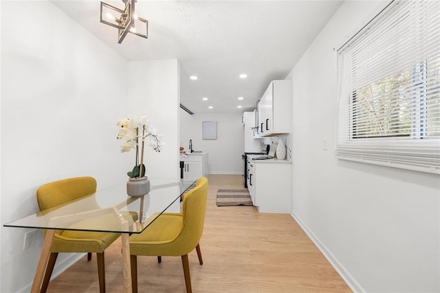 dining room with sink and light hardwood / wood-style flooring