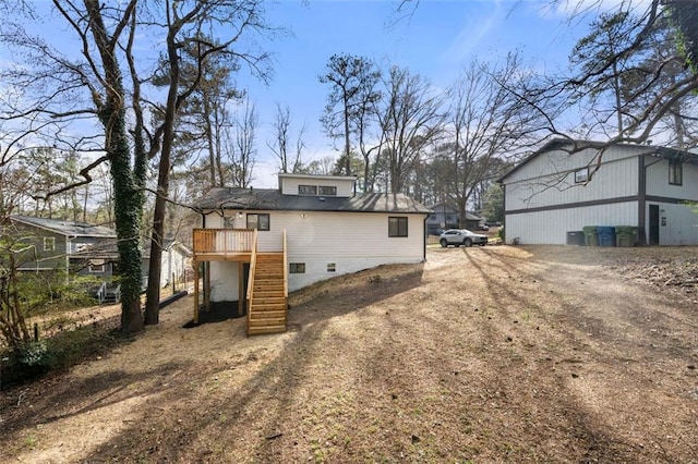 view of side of home with a wooden deck