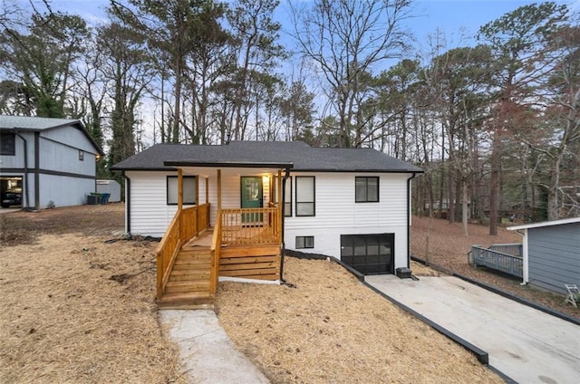 view of front of property with a garage and central AC