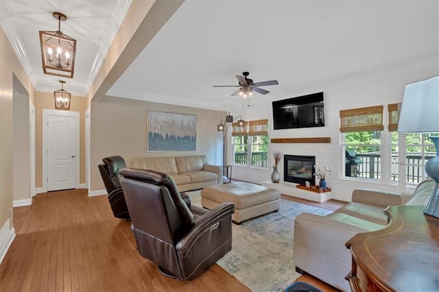 87 Washington Blvd, Dallas, GA 30132 - living room with ornamental molding, a chandelier, wood-type flooring, a large fireplace, and baseboards