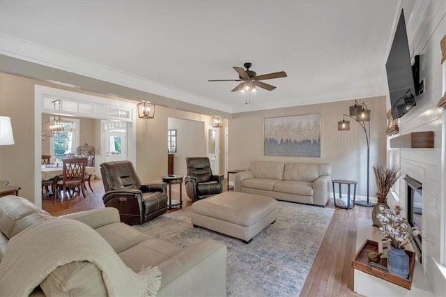 87 Washington Blvd, Dallas, GA 30132 - living room featuring hardwood / wood-style floors, ceiling fan, a glass covered fireplace, crown molding, and baseboards