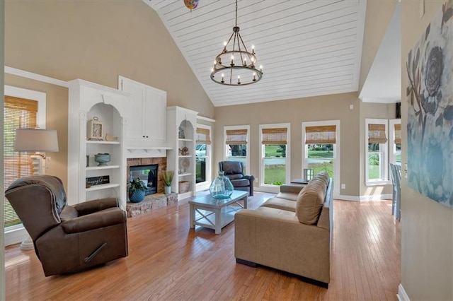 87 Washington Blvd, Dallas, GA 30132 - living room with high vaulted ceiling, a chandelier, light wood finished floors, baseboards, and a glass covered fireplace