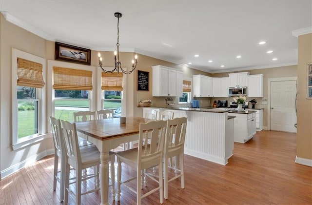 87 Washington Blvd, Dallas, GA 30132 - dining area with ornamental molding, healthy amount of natural light, a chandelier, light wood-style floors, and baseboards