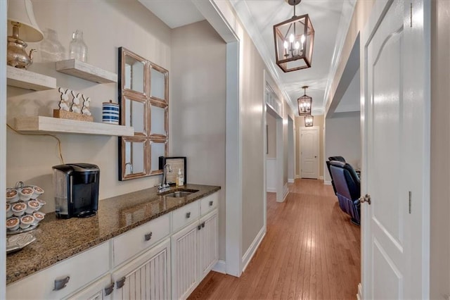 87 Washington Blvd, Dallas, GA 30132 - hallway featuring a sink, light wood finished floors, a chandelier, and baseboards