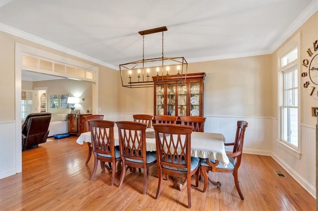 87 Washington Blvd, Dallas, GA 30132 - dining room with light wood-style floors, healthy amount of natural light, a wainscoted wall, ornamental molding, and a chandelier