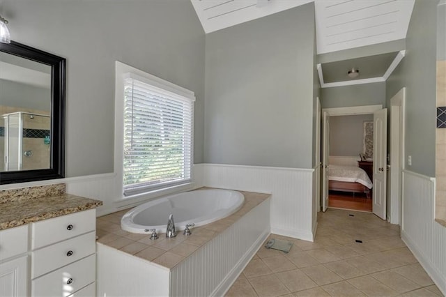 87 Washington Blvd, Dallas, GA 30132 - ensuite bathroom with a wainscoted wall, a shower stall, vaulted ceiling, tile patterned floors, and a garden tub