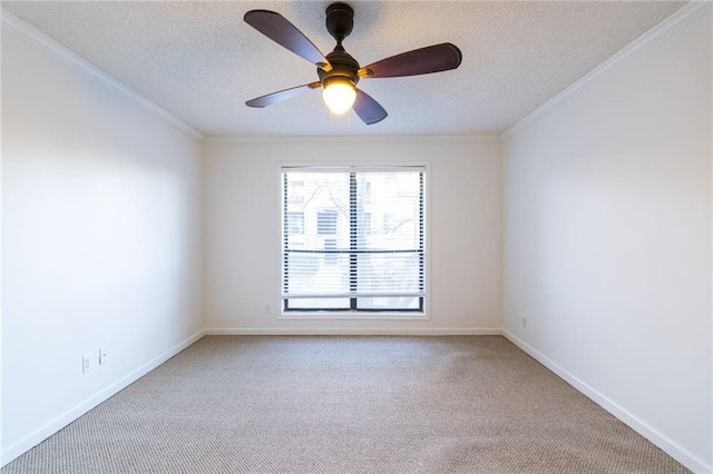 carpeted empty room with ceiling fan, crown molding, and a textured ceiling