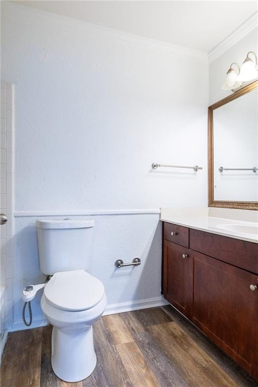 full bathroom with vanity, bathing tub / shower combination, hardwood / wood-style flooring, toilet, and ornamental molding