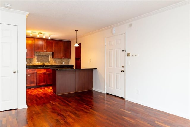 kitchen with tasteful backsplash, hanging light fixtures, ornamental molding, and dark hardwood / wood-style floors