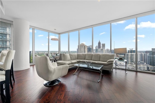 1080 Peachtree St NE Unit 2710, Atlanta, GA 30309 - living area featuring a skyline view, floor to ceiling windows, healthy amount of natural light, and dark wood finished floors