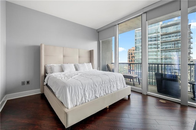 1080 Peachtree St NE Unit 2710, Atlanta, GA 30309 - bedroom with multiple windows, a wall of windows, access to exterior, and wood finished floors
