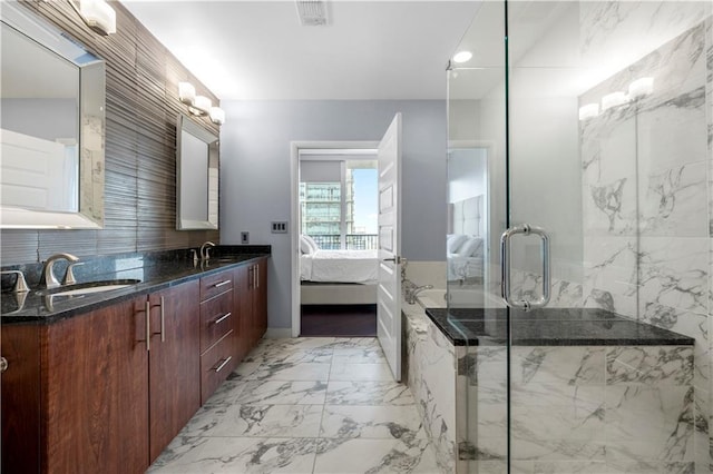 1080 Peachtree St NE Unit 2710, Atlanta, GA 30309 - ensuite bathroom featuring double vanity, a marble finish shower, backsplash, and marble finish floors