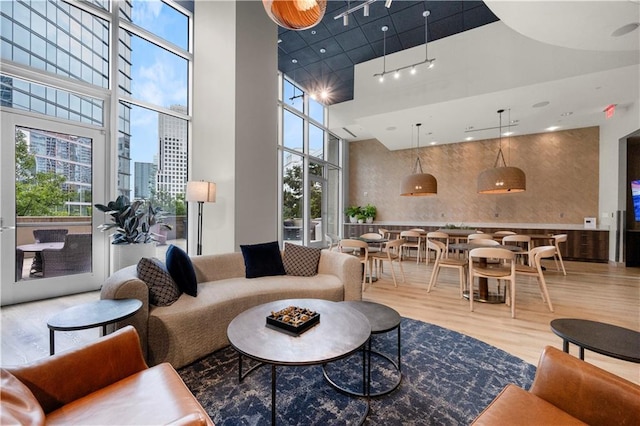 1080 Peachtree St NE Unit 2710, Atlanta, GA 30309 - living area with wood finished floors, a towering ceiling, and rail lighting
