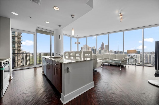 1080 Peachtree St NE Unit 2710, Atlanta, GA 30309 - kitchen with a wall of windows, range, dark wood-type flooring, pendant lighting, and light stone countertops