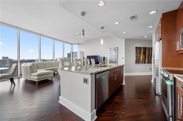 1080 Peachtree St NE Unit 2710, Atlanta, GA 30309 - kitchen featuring stainless steel appliances, open floor plan, dark wood-style flooring, floor to ceiling windows, and a center island with sink