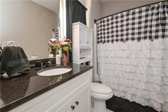 bathroom featuring a shower with shower curtain, toilet, and vanity